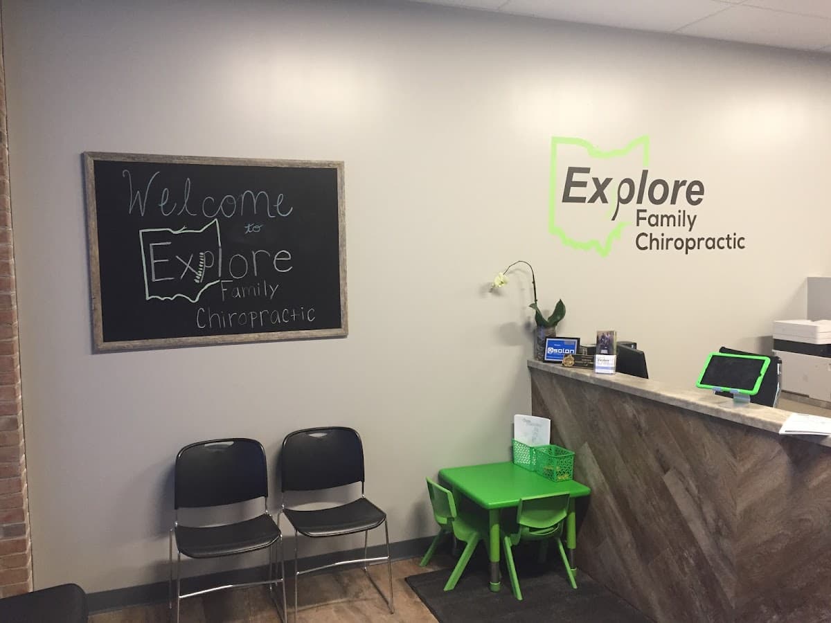 Reception area at Explore Family Chiropractic in Aurora, Ohio, with the green Ohio-outline logo painted on the wall